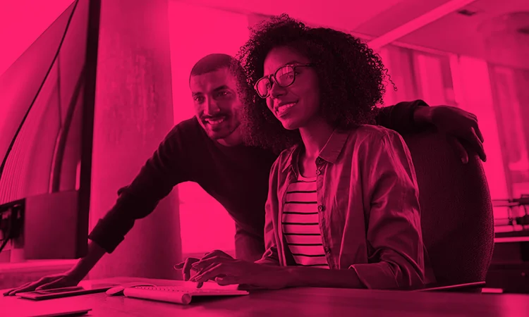 Man and woman on laptop looking into corporate elearning solutions