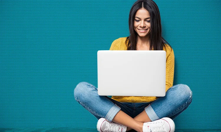Woman on laptop using course creation software