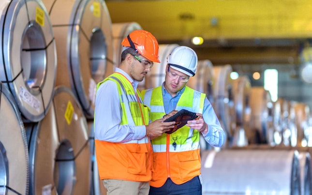 SGS employees doing a quality check in an industrial setting