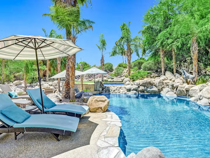 Image of a Vacasa holiday rental with deck chairs and water