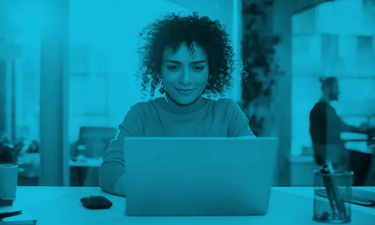 Woman on laptop looking at the best online training platforms for employees