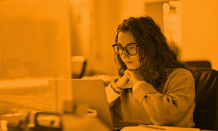 A woman on a laptop taking some employee elearning